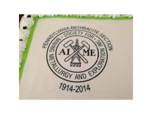 AIME logo on the anniversary cake.